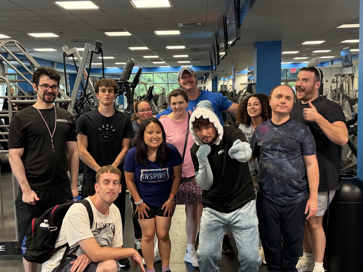 An adaptive fitness group posing together in a gym