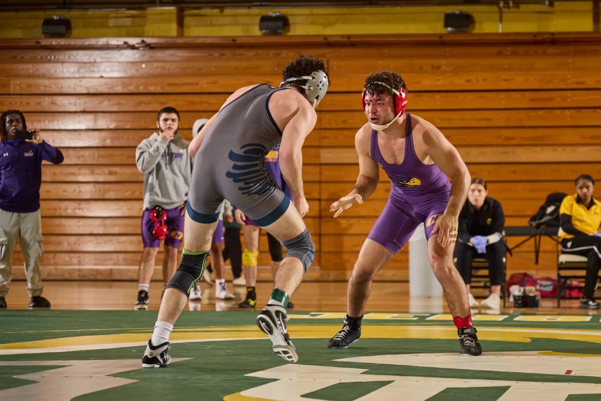 Collegiate wrestlers competing during a match